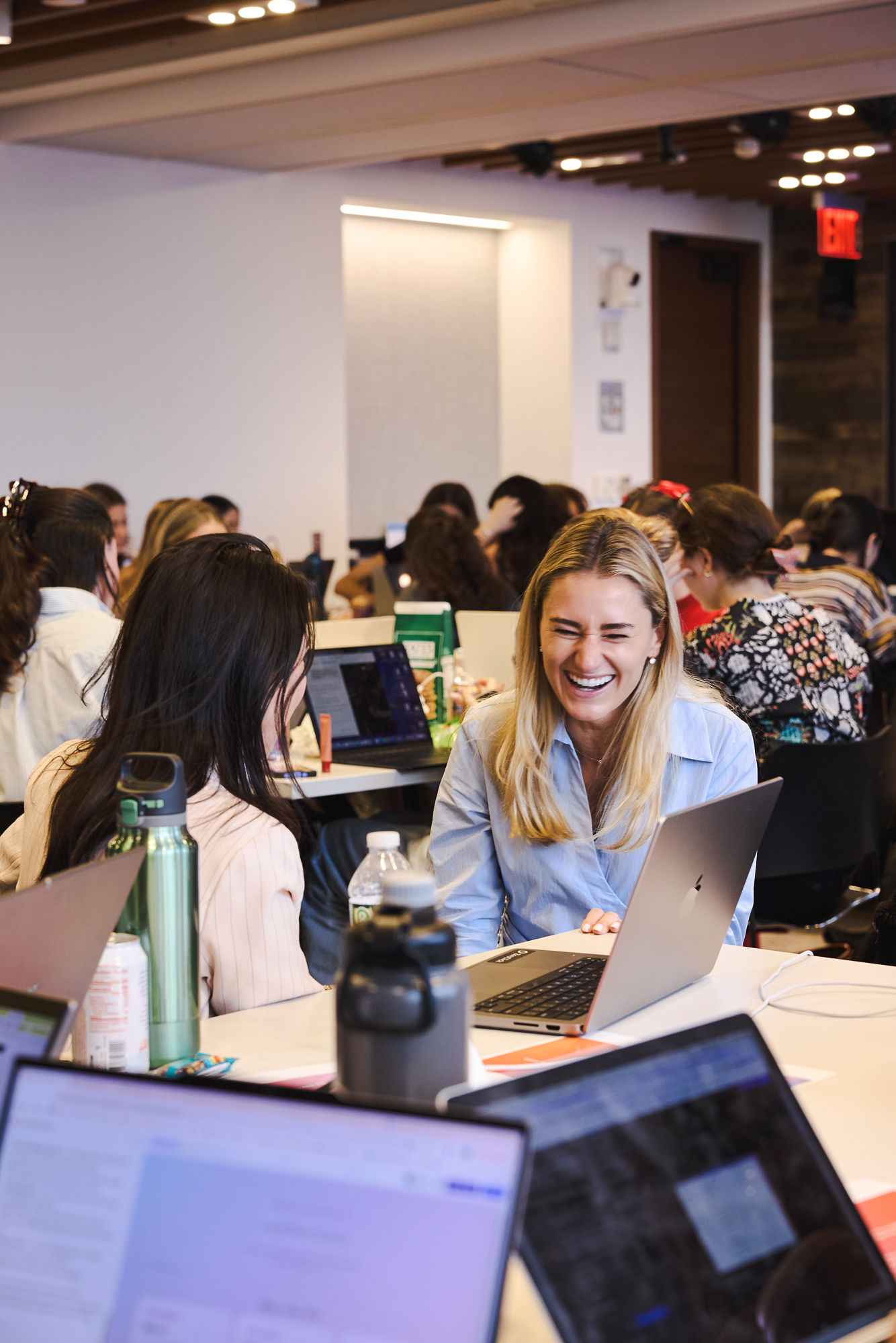 Women laughing together while building at a Model Behavior event
